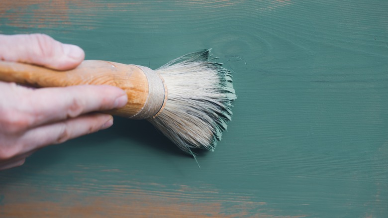 person painting wood