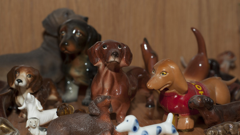 Vintage dog figurines are on display on a shelf