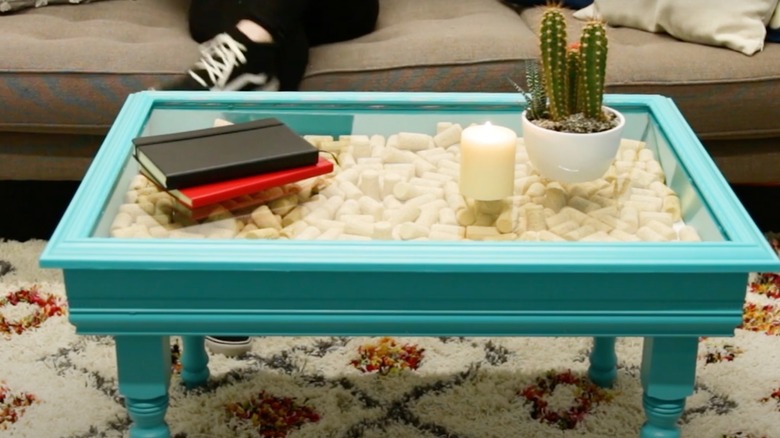 Large blue shadow box with legs used as coffee table