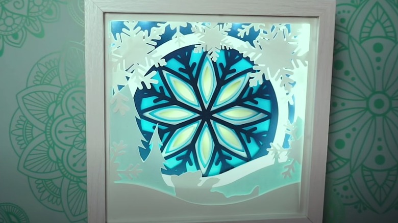 Shadow box with snowflake design lit up with LED lights