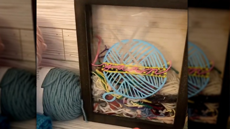 Shadow box filled with scrap yarn pieces