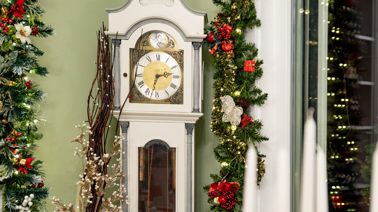 white grandfather clock against wall 