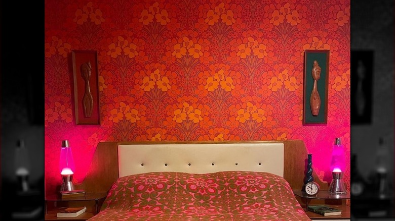 Bed with bright vintage wallpaper