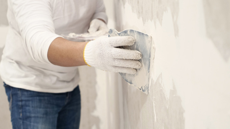 Person plastering walls