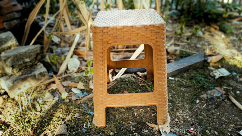 Plastic stool on ground outside