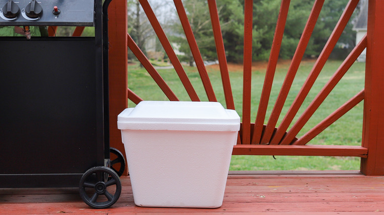 Styrofoam cooler next to grill