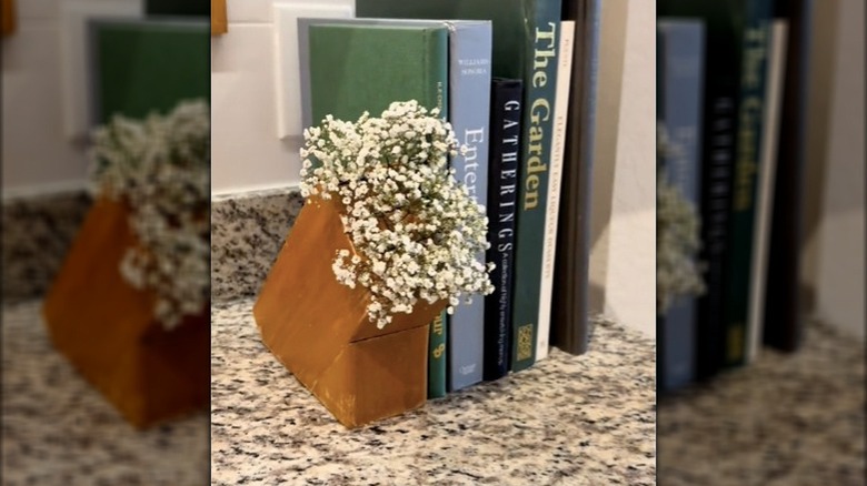 A knife block filled with dried flowers