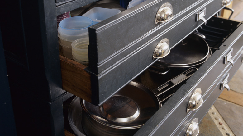 dresser with pans and containers