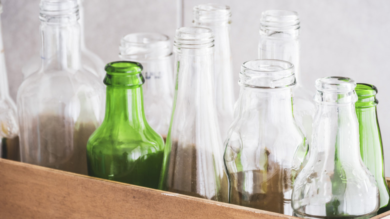 Empty glass bottle in wood box