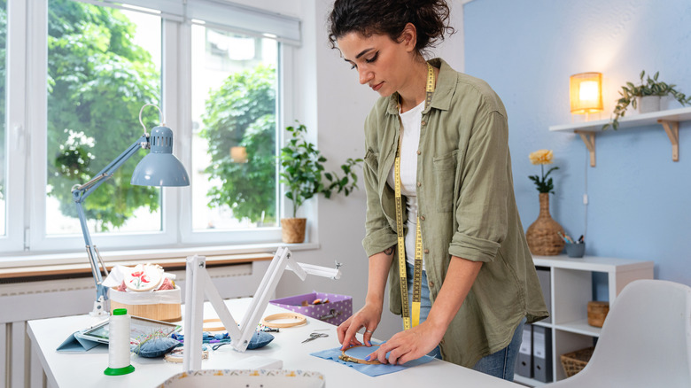 Someone working on a DIY in a craft room