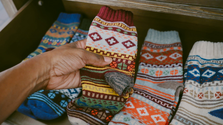 person holding patterned socks