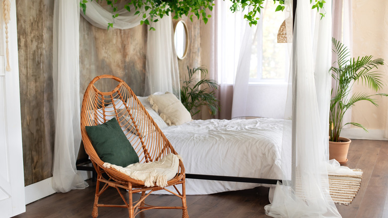 Bed with sheer curtains at the head and foot as a canopy