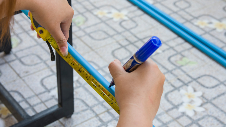 measuring blue pvc pipe