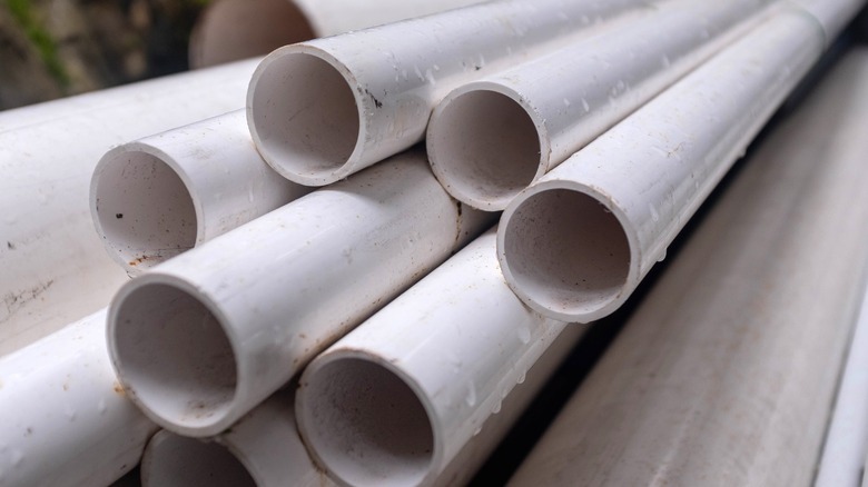 stack of wet PVC pipes