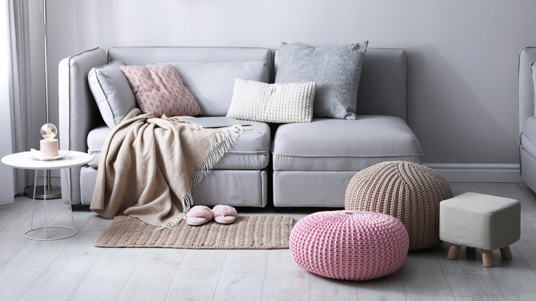 A living room area is decorated with two ottomans