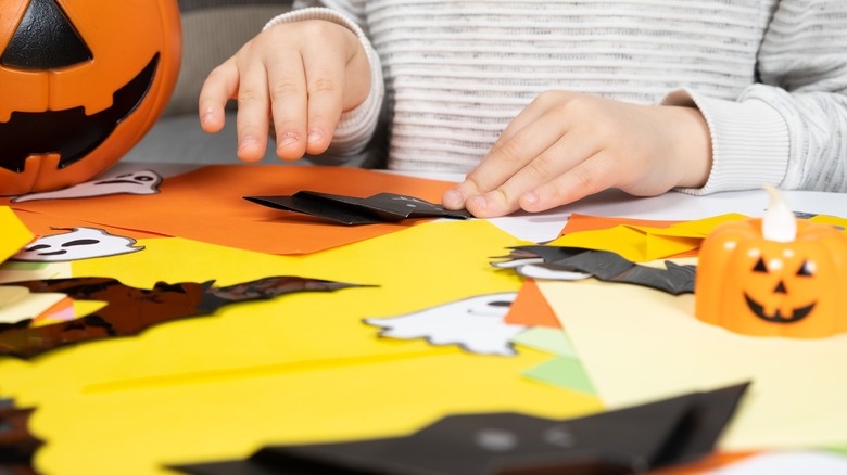 kid making Halloween craft