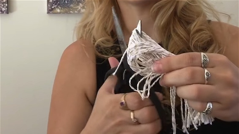 Woman cutting tassels for tieback