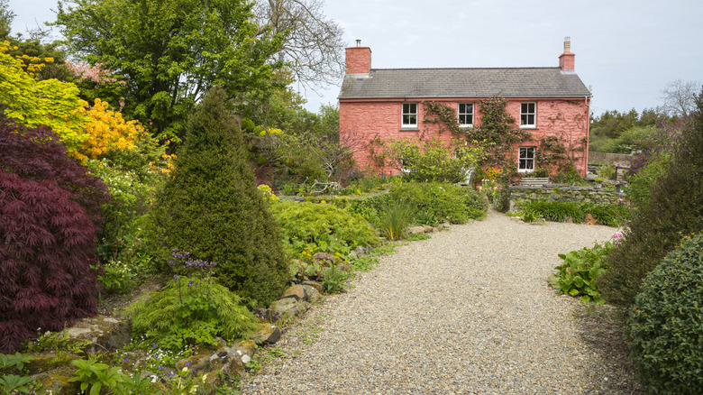 Gravel garden pathway leading to a house