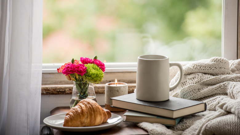 flowers, books, and mug 