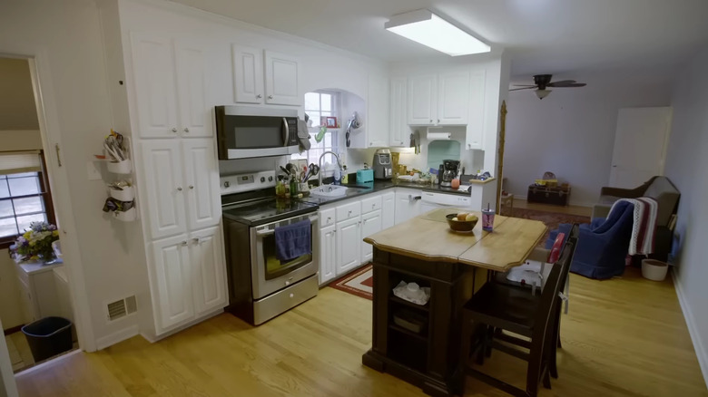 white kitchen joined with living room