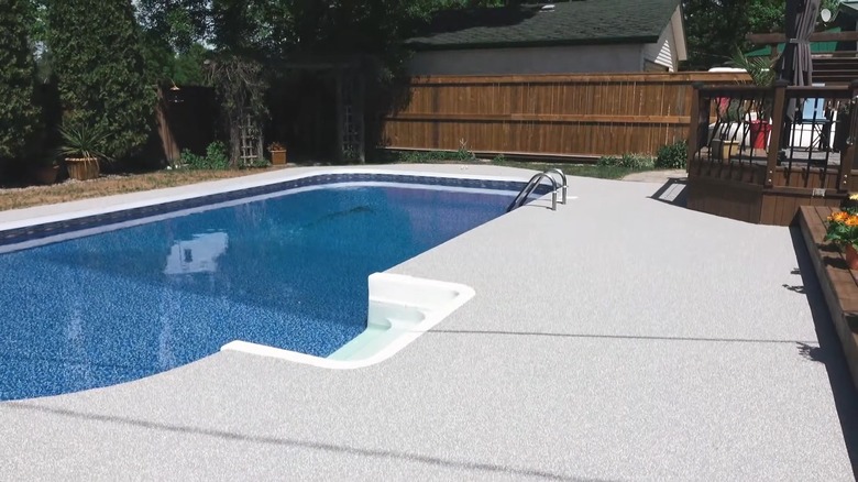 backyard pool with Rubber Stone hardscape