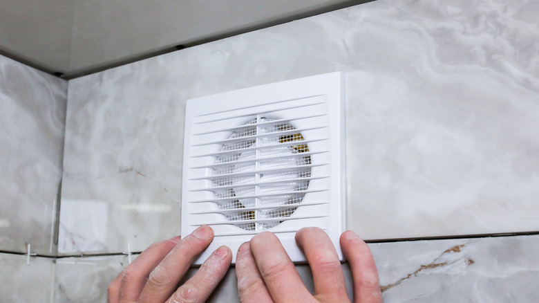 Person touching extractor fan