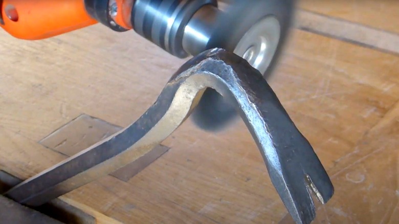 Removing rust from a crowbar using a wire brush