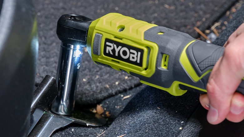 A person using a Ryobi lithium ratchet tool