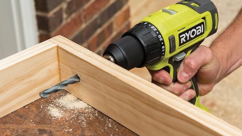 person using a Ryobi drill