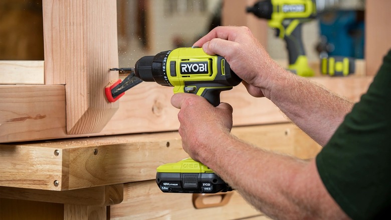 person using Ryobi power drill