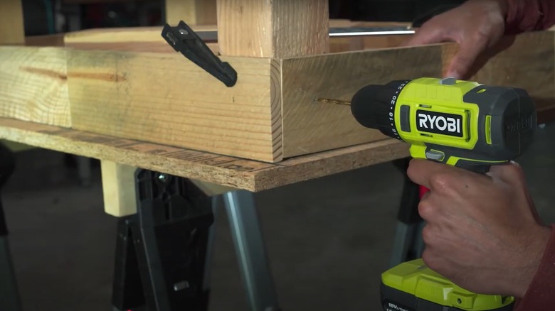 Person using a Ryobi power drill