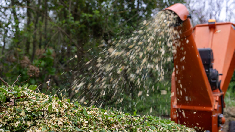 Wood chipper shredding material into compostable waste