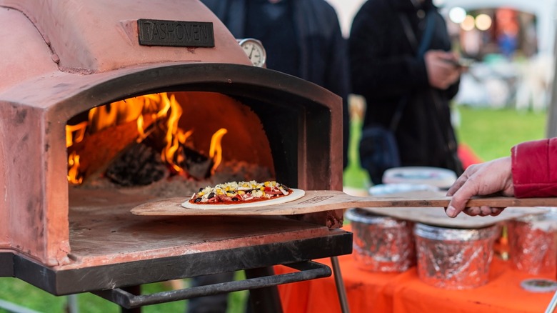 pizza in an outdoor pizza oven