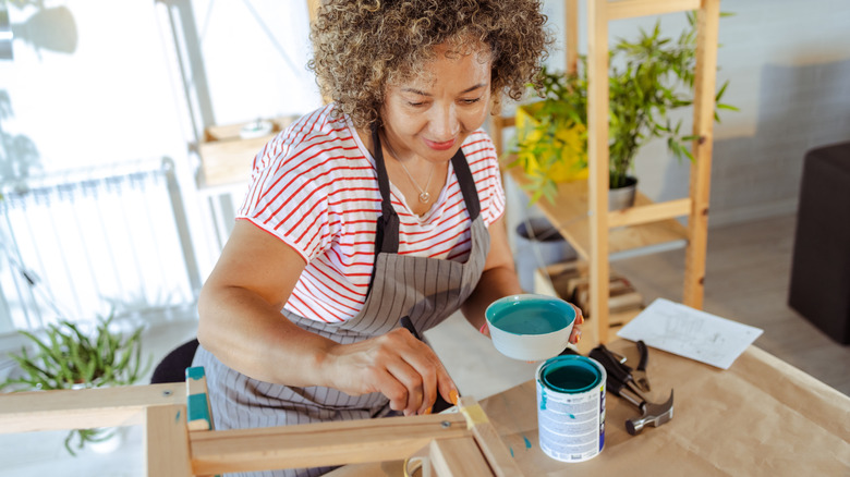 Woman painting piece of furniture