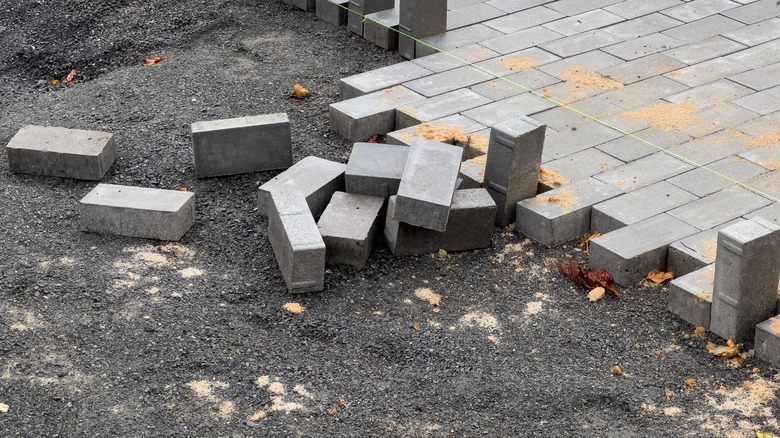 Pavers being laid over gravel