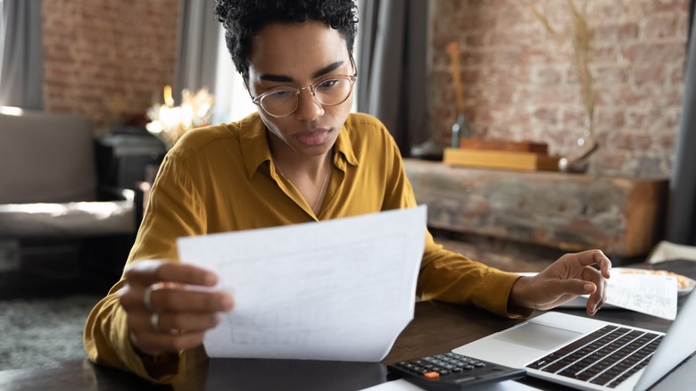 woman studying a paper