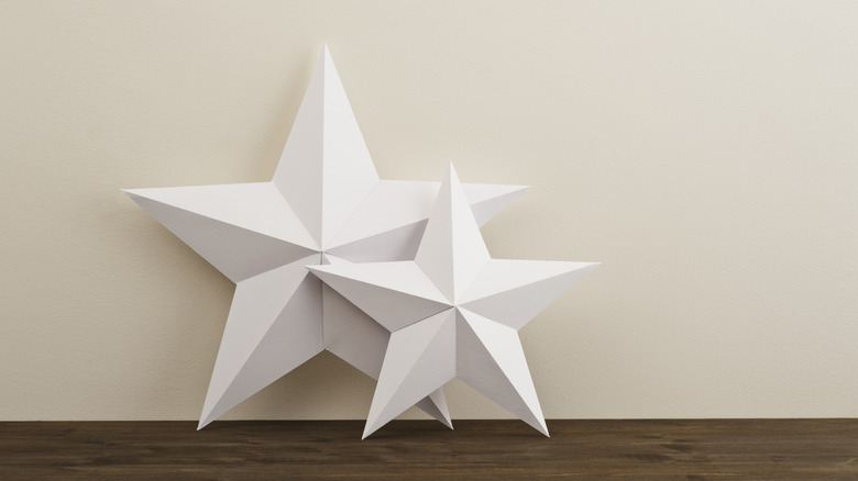 two cardboard stars on a shelf