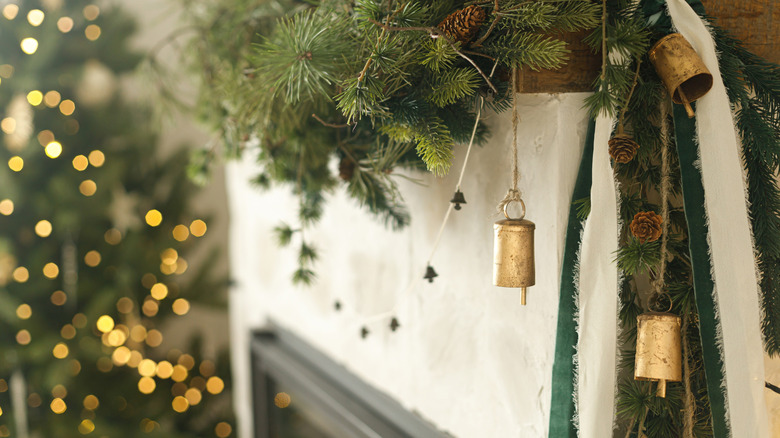 Three golden bells hanging from garland with twine