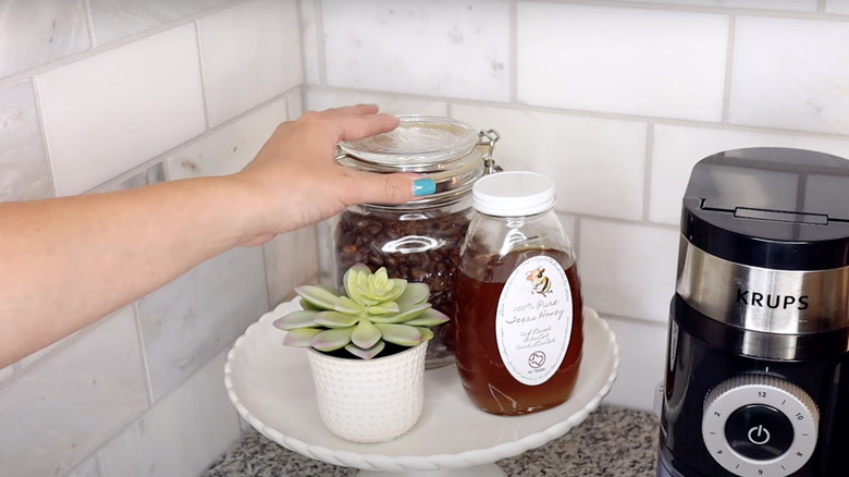 glass jar holding coffee beans