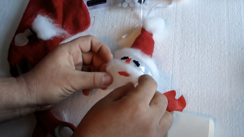 person making Santa light bulb