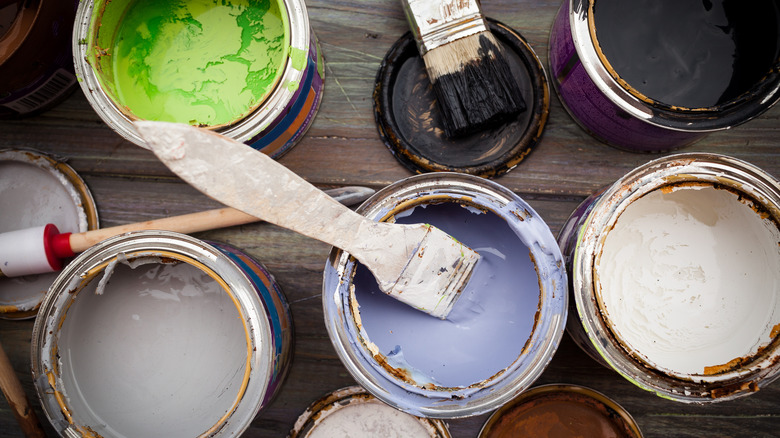 cans filled with old paint