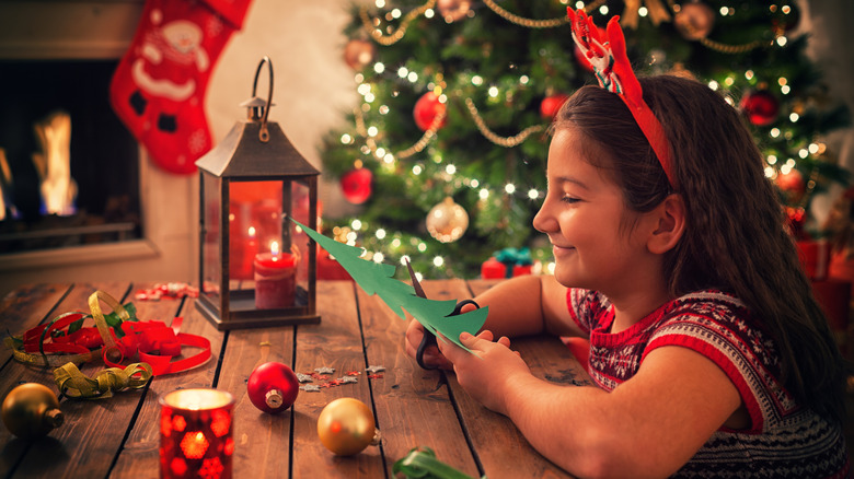 girl completing Christmas crafts