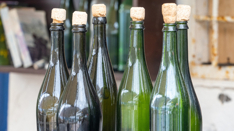 Empty wine bottles of several colors