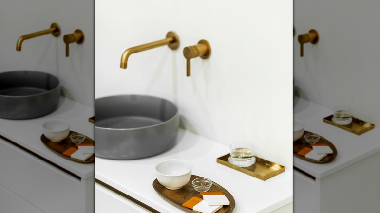 Unique concrete look sink with metal wall fixtures