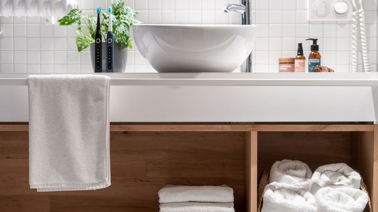 Vessel sink with cabinets beneath storing towels and washcloths