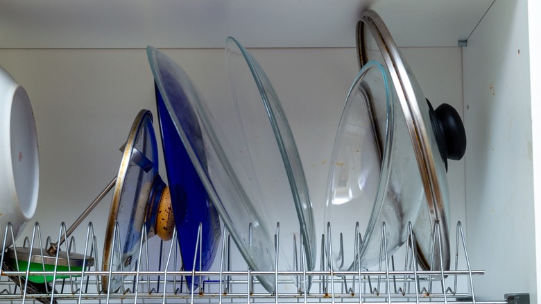 pan lids in dish rack 