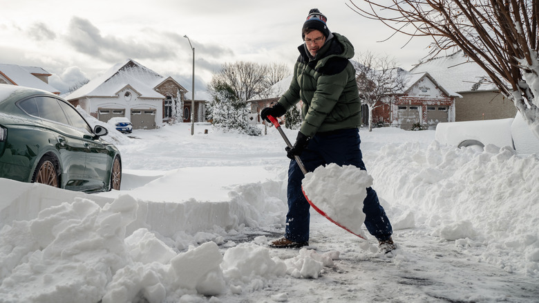 A man shovels a snow walkway