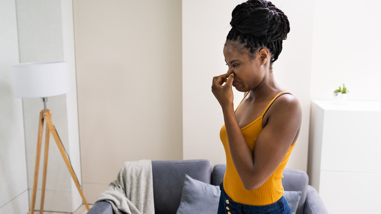 woman smelling something bad