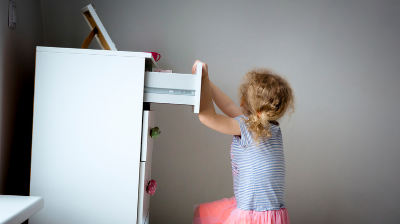 child tipping dresser