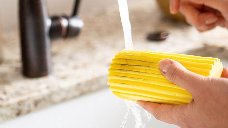 Damp Duster sponge being washed in sink